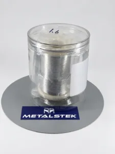 Delivered custom indium wire on a spool inside a clear container, photographed for MetalsTek