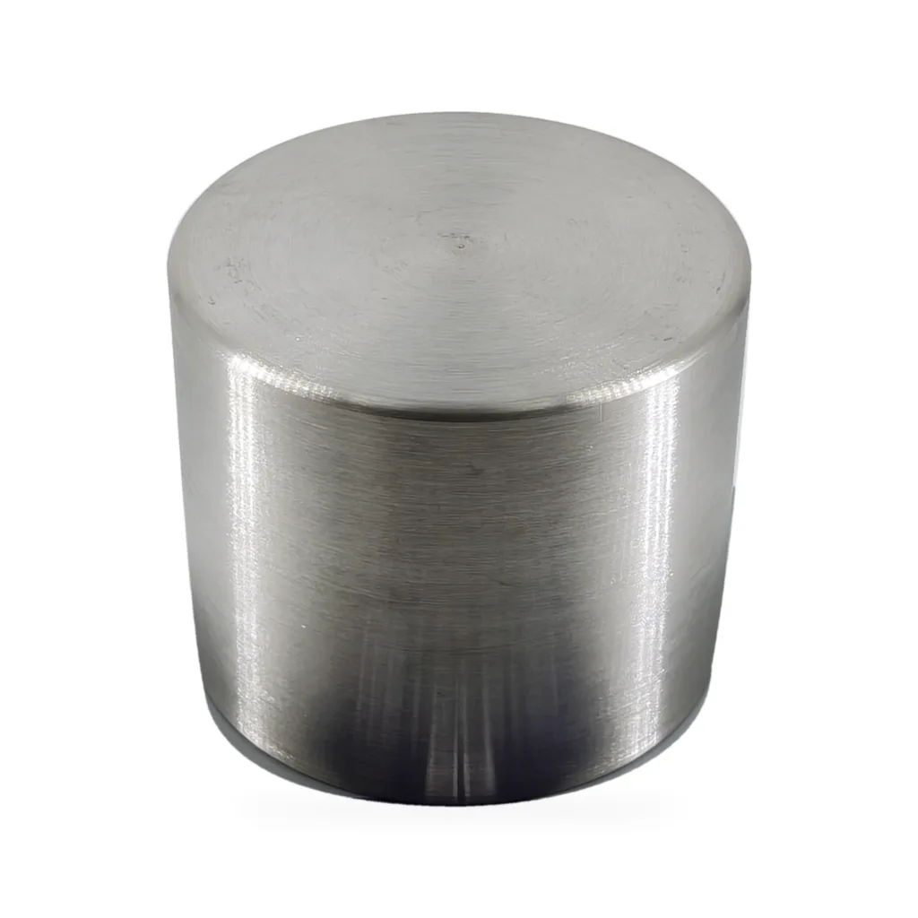 Nickel crucible inverted to show the base and outer wall machining marks on a white background